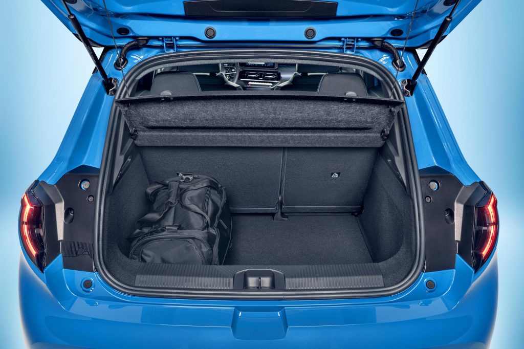 focused view of Micra trunk space with open trunk door, upright seats and black duffel bag in the corner